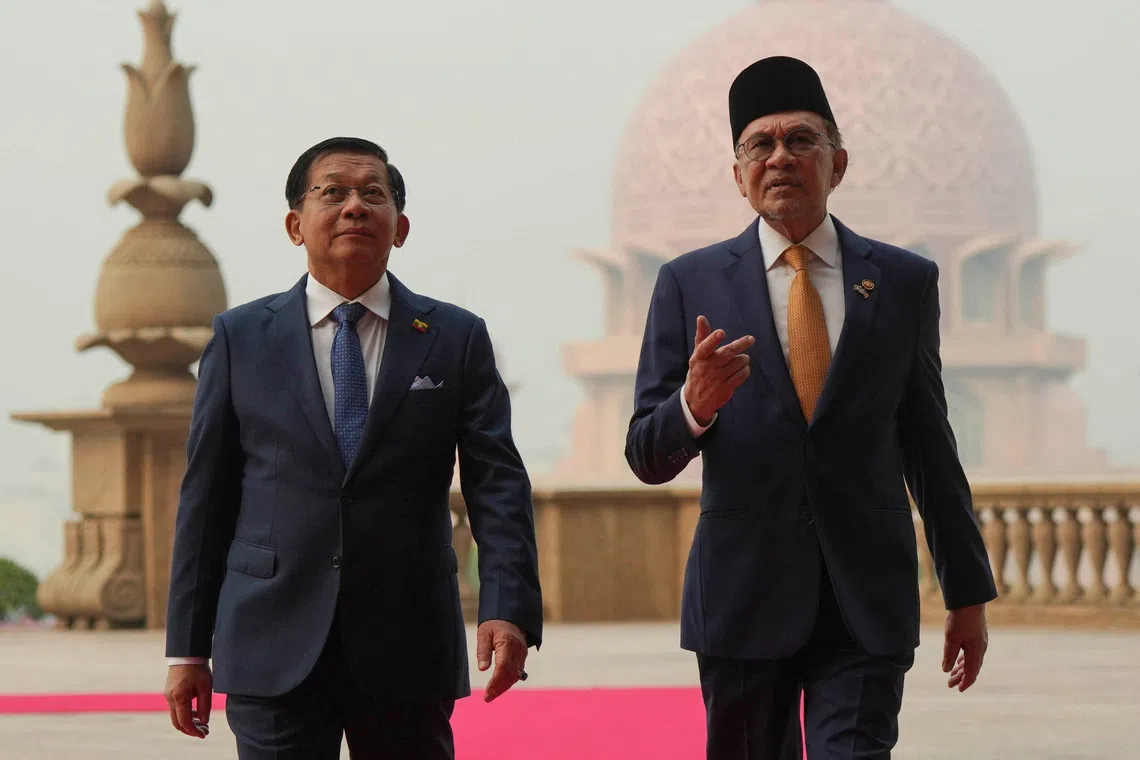 Myanmar’s President Min Aung Hlaing (left) walking with Malaysia’s Prime Minister Anwar Ibrahim in Putrajaya on Oct 8.