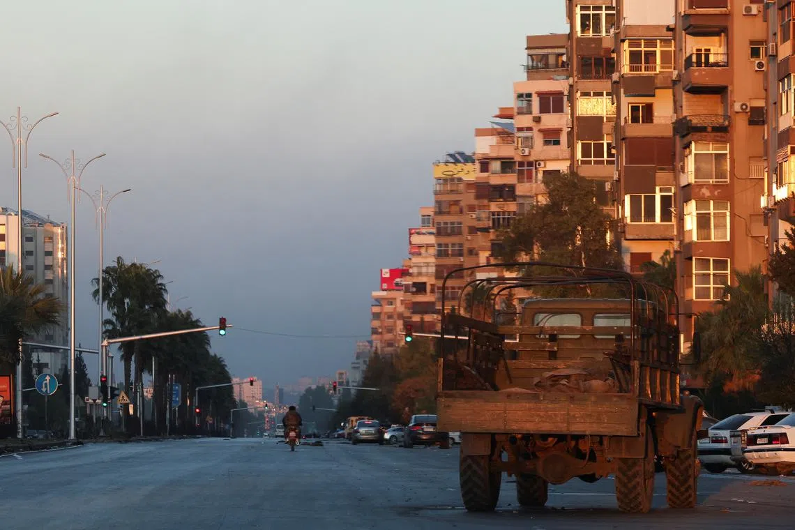 A man rides a bike on a street, after Syrian rebels announced that they have ousted Syria's Bashar al-Assad, in Damascus, Syria, December 8, 2024. REUTERS/Mohamed Azakir