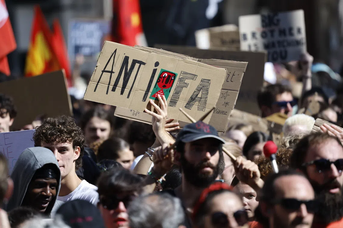 A protester holds a sign reading 'Antifa' at a rally following a call for action by 'Bloquons tout' (Block everything) collective in Montpellier, France, on Sept 10.