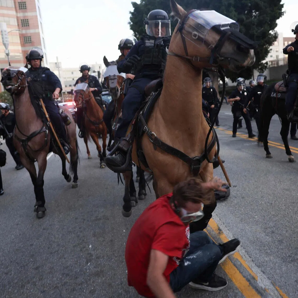 A protester is knocked to the ground by an LAPD mounted police horse as officers evacuate the area following clashes near the Metropolitan Detention Center during the "No Kings" national day of protest in Los Angeles on March 28, 2026. Nationwide protests against US President Donald Trump are expected Saturday as millions of people vent fury over what they see as his authoritarian bent and other forms of cruel, law-trampling governance. It is the third time in less than a year that Americans will take to the streets as part of a grassroots movement called "No Kings," the most vocal and visual conduit for opposition to Trump since he began his second term in January 2025. (Photo by Etienne Laurent / AFP)