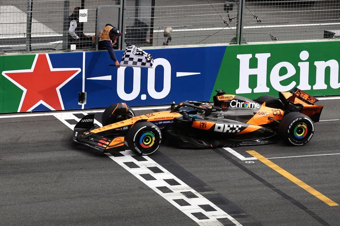 Formula One F1 - Dutch Grand Prix - Circuit Zandvoort, Zandvoort, Netherlands - August 31, 2025 McLaren's Oscar Piastri passes the chequered flag to win the Dutch Grand Prix REUTERS/Jakub Porzycki