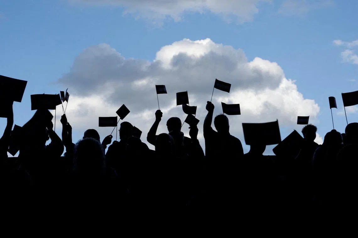 FILE PHOTO: People wave flags on the day of the election campaign kick-off of Austria's Freedom Party (FPOe) in Graz, Austria, September 7, 2024. REUTERS/Leonhard Foeger/File Photo
