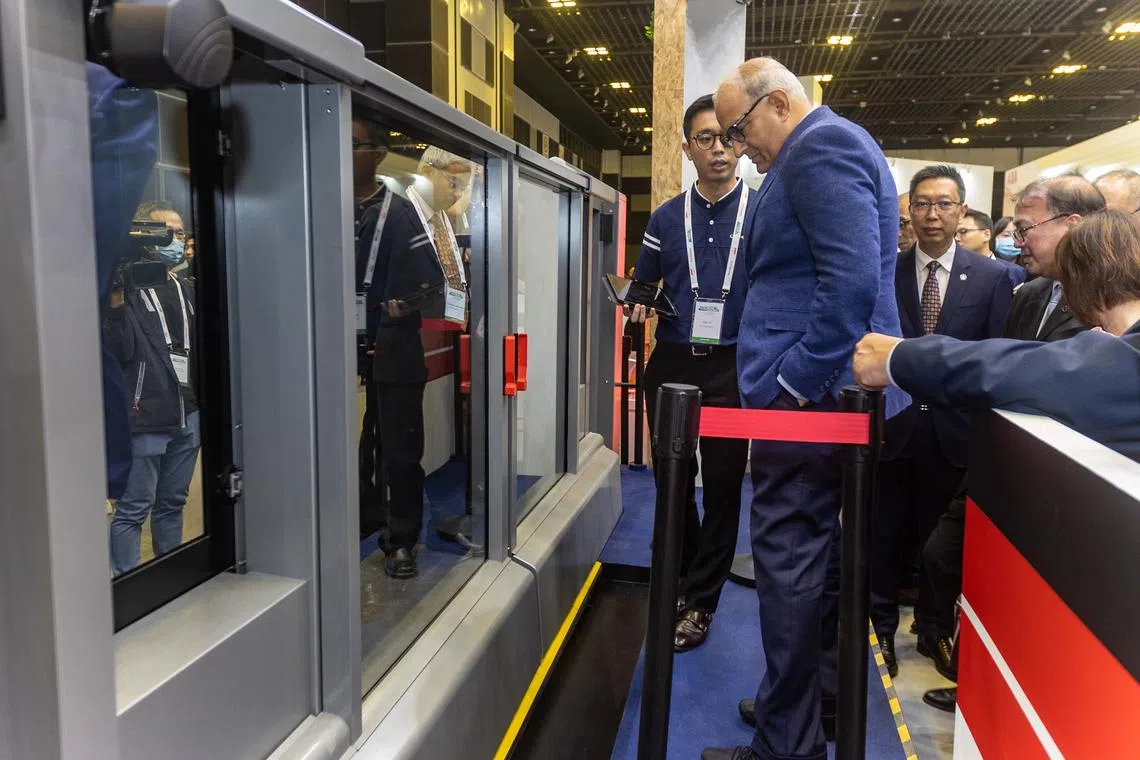 Transport Minister S. Iswaran testing a set of enhanced MRT platform screen doors at the Singapore International Transport Congress and Exhibition held at Suntec Suntec Singapore Convention and Exhibition Centre.
