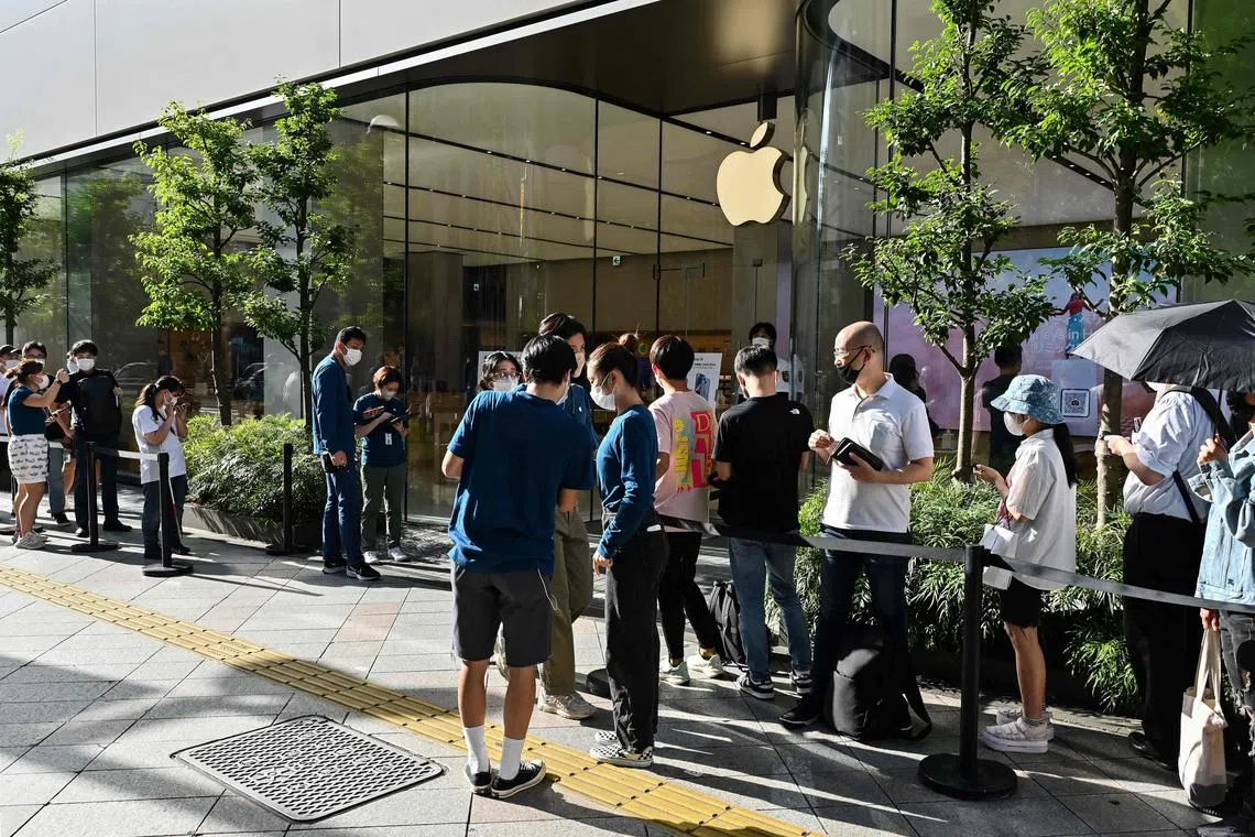Customers queue outside an Apple store for the launch of the new iPhone 14 in Tokyo, in September. 