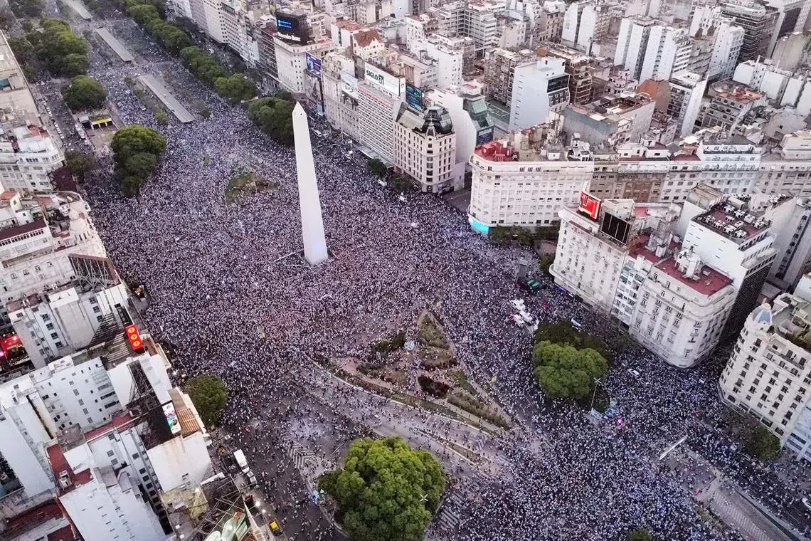 Soccer Football - FIFA World Cup Qatar 2022 - Fans in Buenos Aires watch Argentina v Croatia - Buenos Aires, Argentina - December 13, 2022 Argentina fans celebrate after the match at the Obelisk as Argentina progress to the final REUTERS/Agustin Marcarian TPX IMAGES OF THE DAY