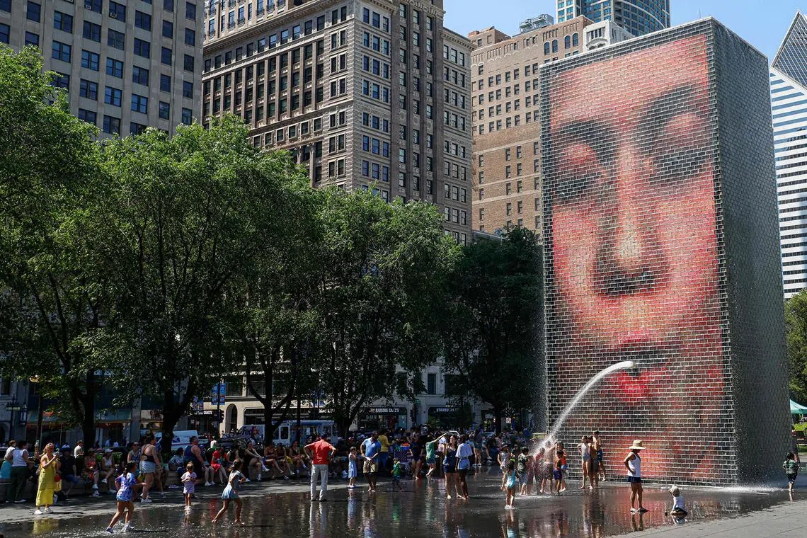 People cooling off in Crown Fountain in Millennium Park as temperatures climbed to over 35 degrees celsius in Chicago, Illinois, on June 21, 2025. 
