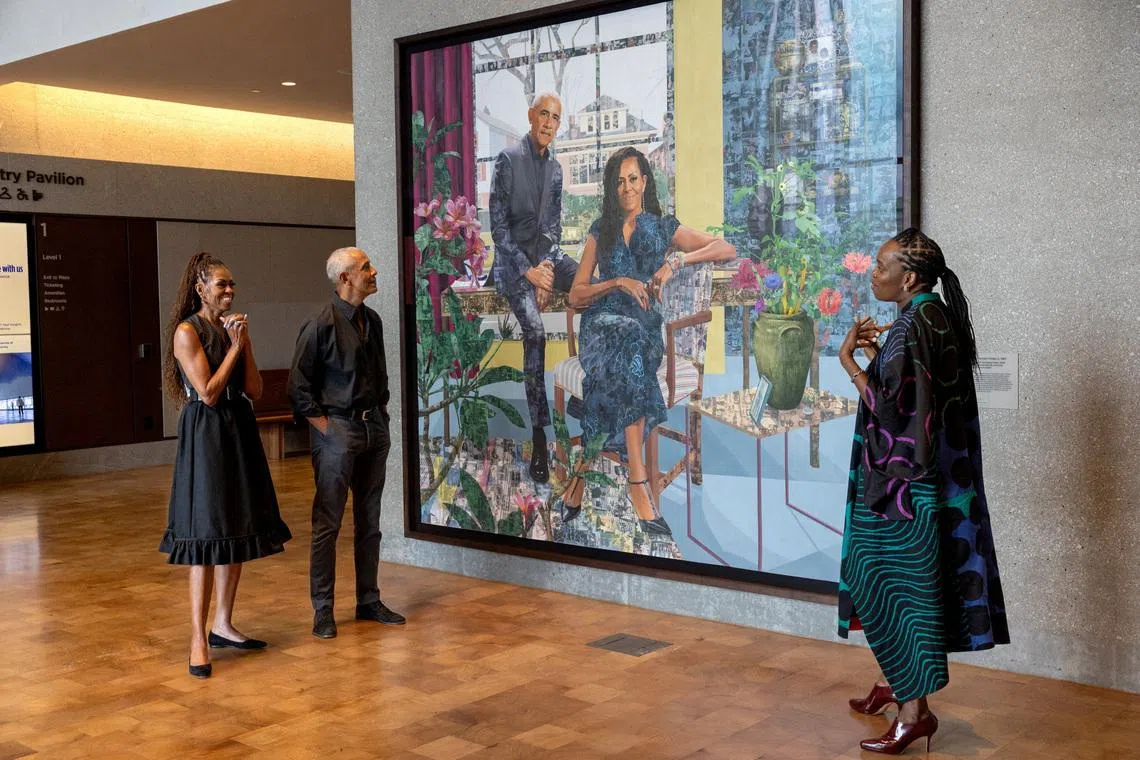 Former president Barack Obama and former first lady Michelle Obama with Nigerian-born visual artist Njideka Akunyili Crosby next to their first commissioned portrait by Crosby, at the Obama Presidential Center on June 14.