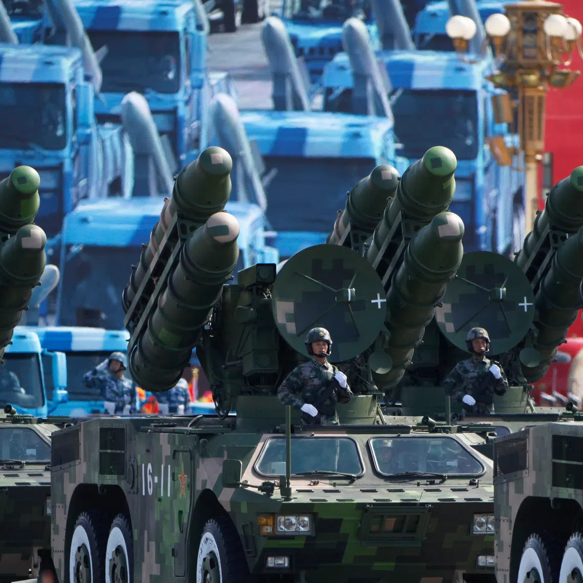 Soldiers stand in People's Liberation Army (PLA) rocket launcher trucks they rumble past Tiananmen Square in a massive parade to mark the 60th anniversary of the founding of the People's Republic of China in Beijing October 1, 2009. REUTERS/David Gray