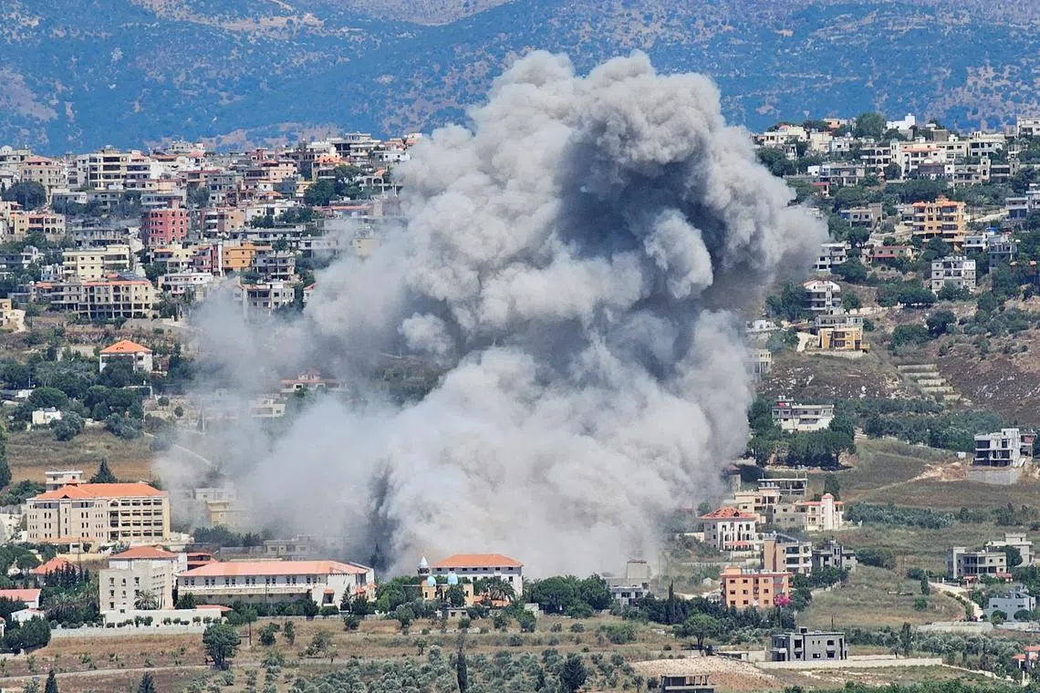 Smoke rises from the southern Lebanese town of Khiam, amid ongoing cross-border hostilities between Hezbollah and Israeli forces, as pictured from the town of Qlayaa, southern Lebanon June 25, 2024. REUTERS/Stringer