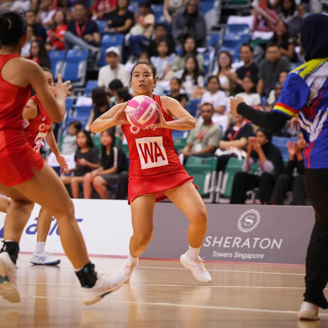Singapore's Angelina Lim (centre) in the thick of the action against Malaysia during their Singlife Nations Cup match at OCBC Arena Hall 1 on Nov 7, 2025.