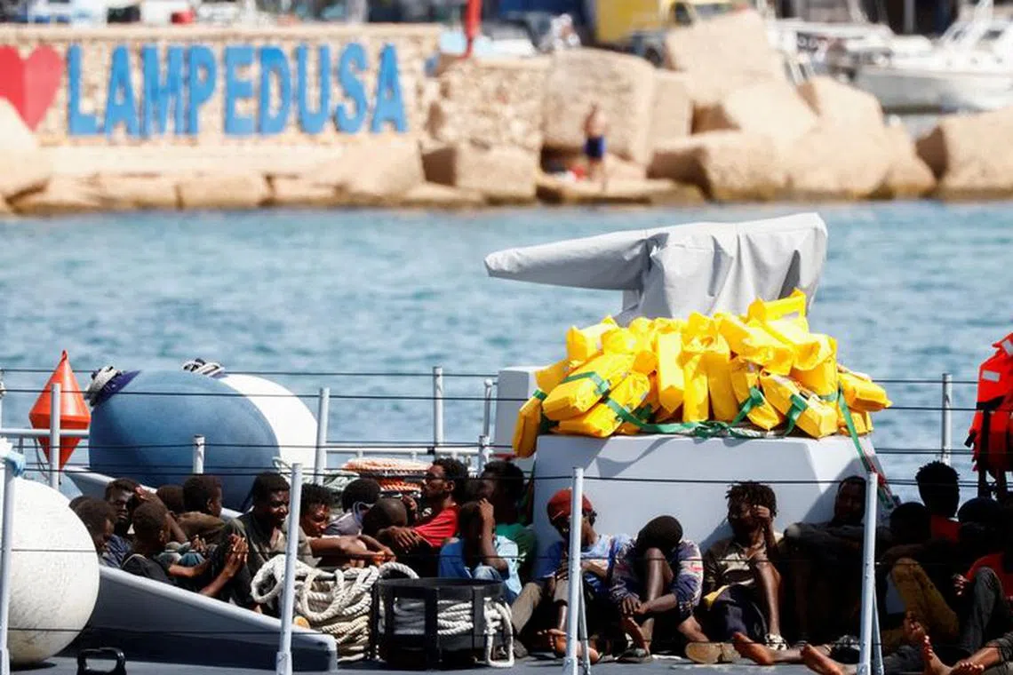 FILE PHOTO: Migrants arrive on an Italian Coast Guard vessel after being rescued at sea, on the Sicilian island of Lampedusa, Italy, September 18, 2023. REUTERS/Yara Nardi/File Photo