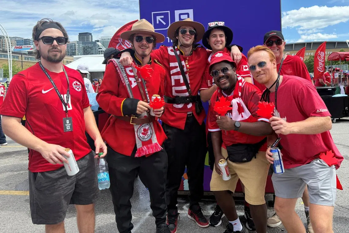Liam Delaney poses for a group photo outside Toronto Stadium after going straight from work to catch a glimpse of the Canadian football team, ahead of the FIFA World Cup 2026 Group B opener between Canada and Bosnia and Herzegovina in Toronto, Ontario, Canada, June 12, 2026. Picture taken with a mobile phone. REUTERS/Kyaw Soe Oo