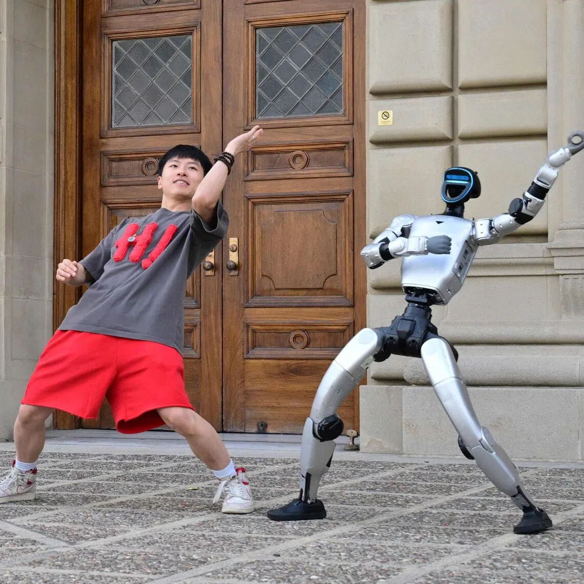Chinese street dancer Wu Yufei performs alongside Unitree Robotics humanoid robots during a demonstration in Pasadena, California, on Sept 17.