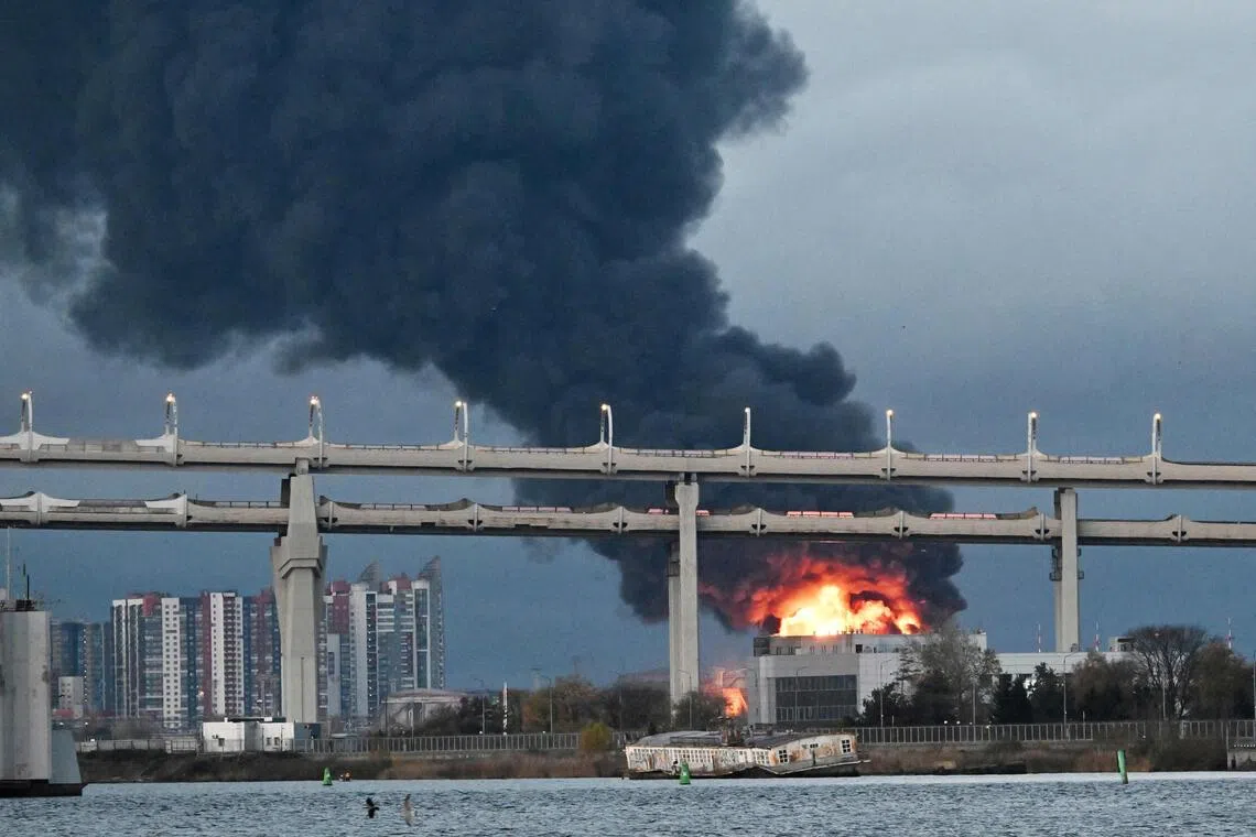 Smoke rises above the city following an air attack on the oil terminal in Saint Petersburg on Oct 18.