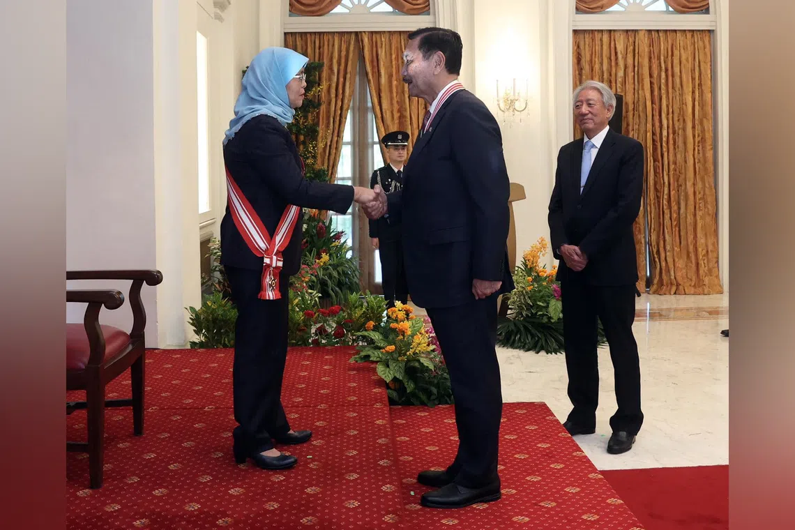 President Halimah Yacob (left) conferring the Distinguished Service Order on Coordinating Minister for Maritime Affairs and Investments Luhut Binsar Pandjaitan at the Istana on June 5.