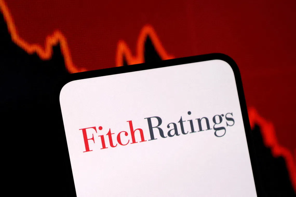 FILE PHOTO: The Fitch Ratings logo and a decreasing stock graph are seen in this illustration taken on January 29, 2025. REUTERS/Dado Ruvic/Illustration/File Photo