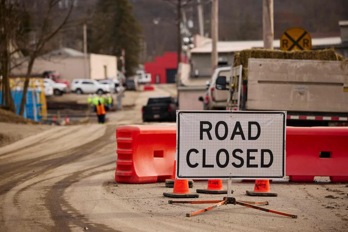 EAST PALESTINE, OH - FEBRUARY 14: A road sign stops traffic near the site of a train derailment on February 14, 2023 in East Palestine, Ohio. A train operated by Norfolk Southern derailed on February 3, releasing toxic fumes and forcing evacuation of residents.   Angelo Merendino/Getty Images/AFP (Photo by Angelo Merendino / GETTY IMAGES NORTH AMERICA / Getty Images via AFP)