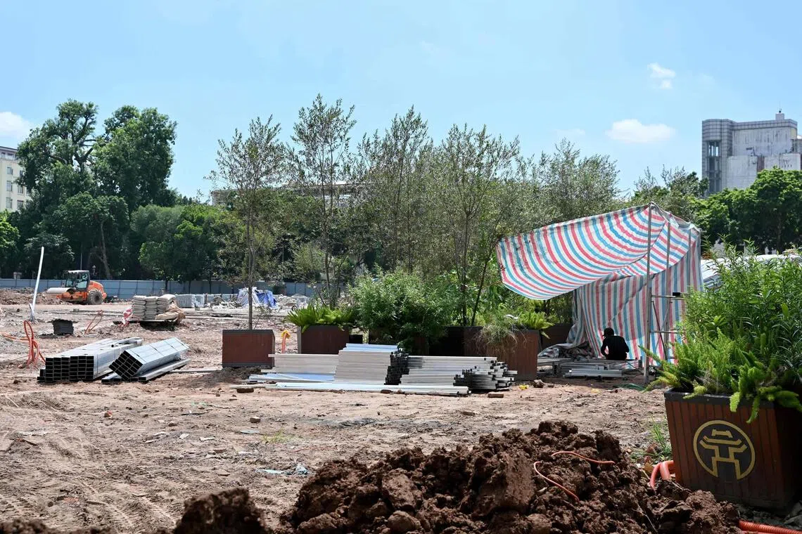 A worker carries out construction at a landscape renovation site near the Hoan Kiem Lake in Hanoi.