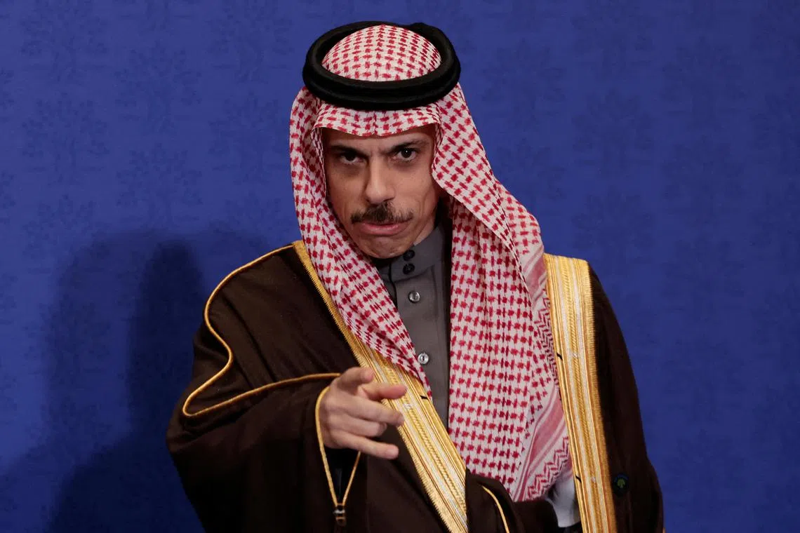 FILE PHOTO: Saudi Foreign Minister Prince Faisal bin Farhan Al-Saud points his finger towards the camera ahead a family photo with other G7 foreign ministers as they meet in Fiuggi, Italy, November 25, 2024. REUTERS/Remo Casilli/File Photo