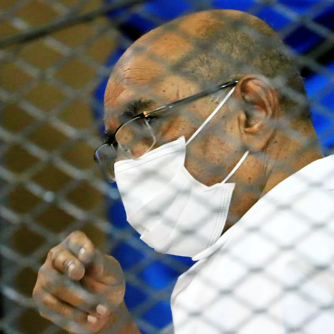 FILE PHOTO: Sudan's ousted President Omar al-Bashir is seen inside the defendant's cage at a courthouse in Khartoum, Sudan September 15, 2020. REUTERS/Mohamed Nureldin Abdallah/File Photo