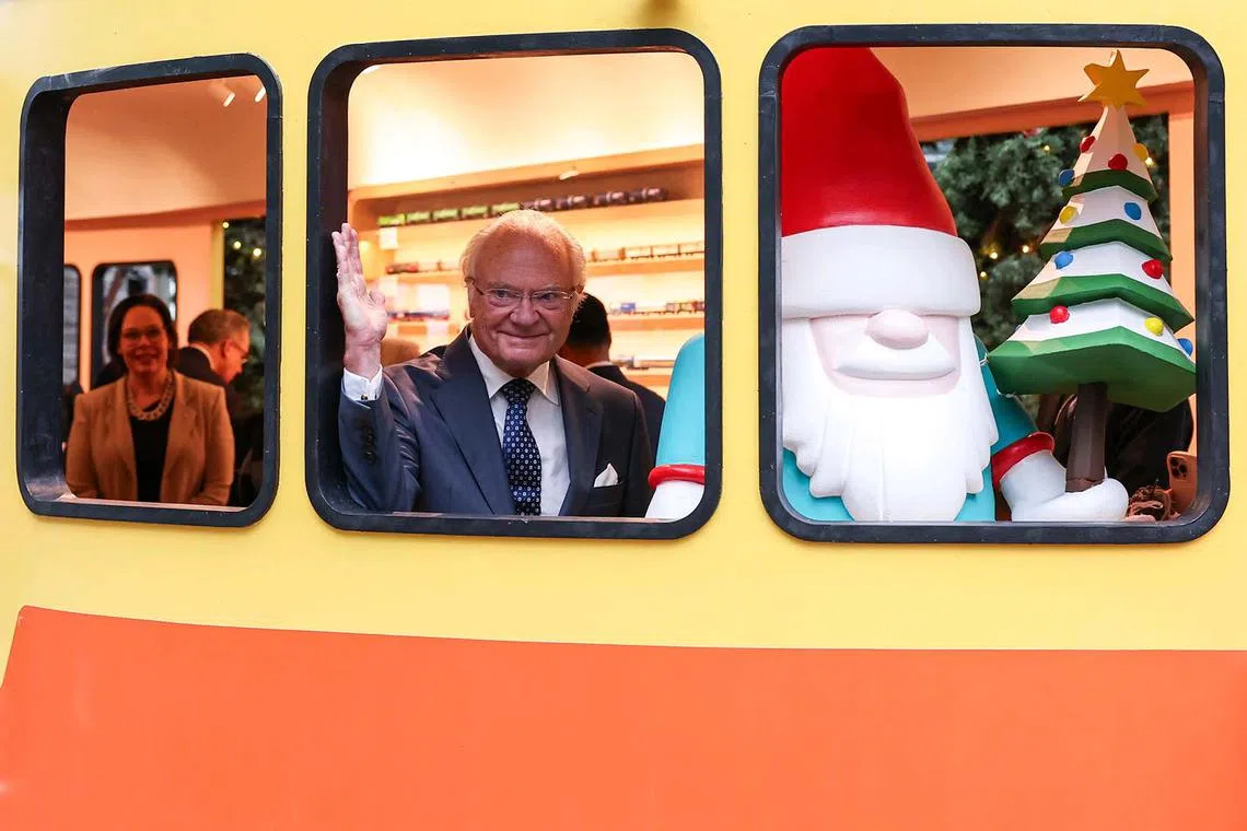 ST20241121_202479600593/pixsweden21/Brian Teo/Tay Hong Yi/King of Sweden Carl XVI Gustaf waving to members of the media from the Swedish railbus during the preview of the Christmas Train Show in the flower dome at Gardens by the Bay on Nov 21, 2024. ST PHOTO: BRIAN TEO