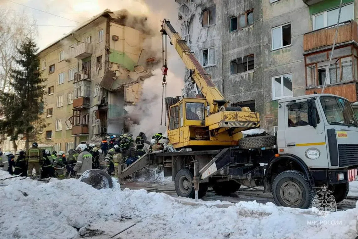 Rescuers remove the rubble of a five-floor residential building heavily damaged in a gas explosion in Novosibirsk, on Feb 9, 2023.