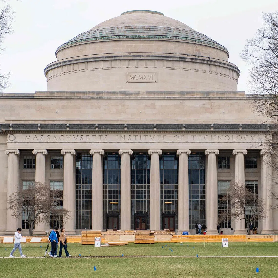 (FILES) People walk on the campus of Massachusetts Institute of Technology (MIT) in Cambridge, Massachussetts, on April 15, 2025. Top US university MIT on October 10 became the first higher education institute to reject a White House offer of federal funding if it brought its policies in line with US President Donald Trump's conservative agenda. The government's proposal, sent to nine universities in early October, would require the institutions to stop considering factors related to gender, ethnicity, race and other factors when admitting students, among other stipulations, if they wanted to receive federal funding. (Photo by Joseph Prezioso / AFP)