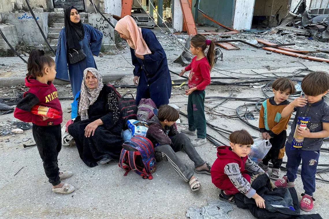 Displaced Palestinians ordered by the Israeli military to evacuate the northern part of Gaza take a rest as they flee amid an Israeli military operation, in Jabalia in the northern Gaza Strip October 23, 2024. REUTERS/Hassan Al-Zaanin/File Photo