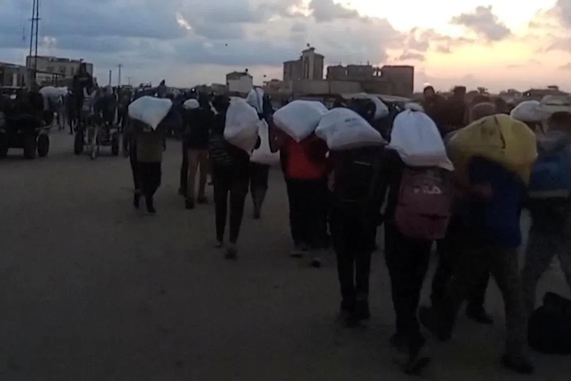 Palestinians carry aid supplies which they received from the U.S.-backed Gaza Humanitarian Foundation, in Rafah, in the southern Gaza Strip, June 3, 2025, in this screengrab taken from video. Reuters TV via REUTERS/ File Photo