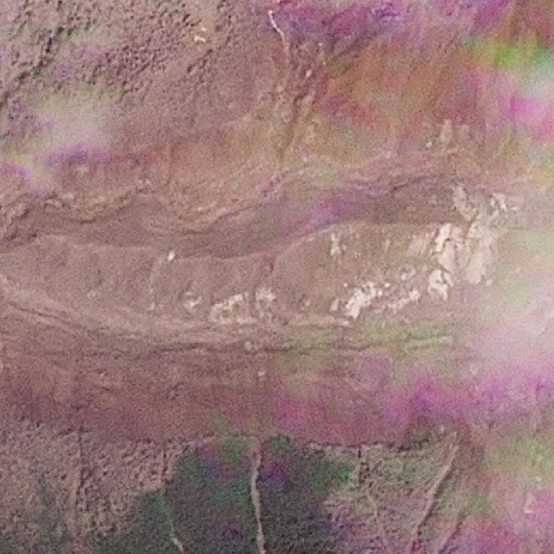 A satellite view shows a lake building up where a glacier collapse set off a deadly cascade of ice, mud and debris.