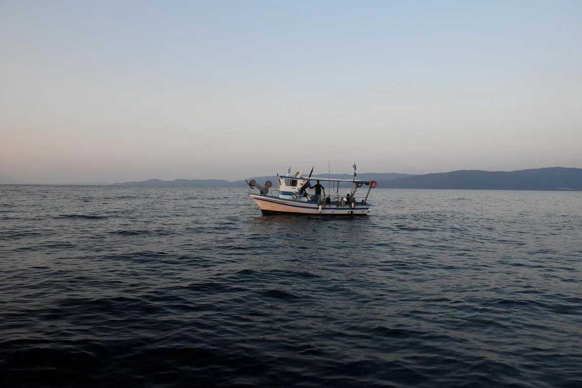 A fishing boat sails near the shores of Asprovalta, Greece, June 12, 2018. REUTERS/Alexandros Avramidis/File Photo