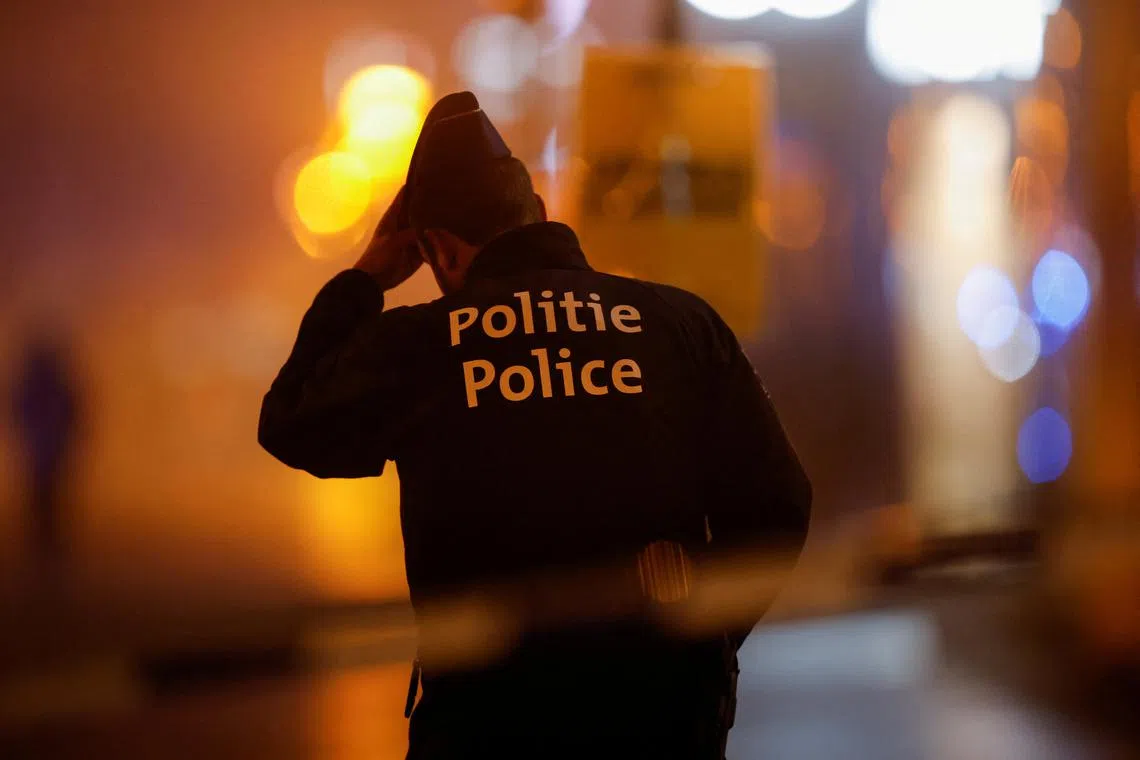 FILE PHOTO: A Belgian police officer stands guard outside the area where, according to police, a shooting took place, injuring several police officers, in Brussels, Belgium, December 6, 2023. REUTERS/Johanna Geron/File Photo