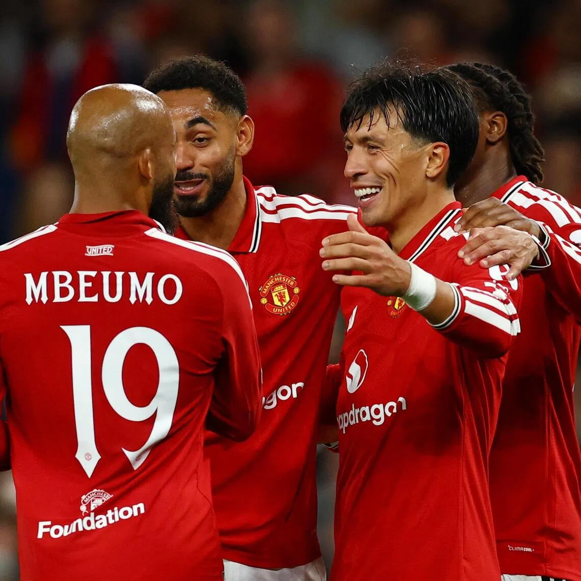 Manchester United’s Lisandro Martinez celebrates scoring their fourth and final goal with teammates.