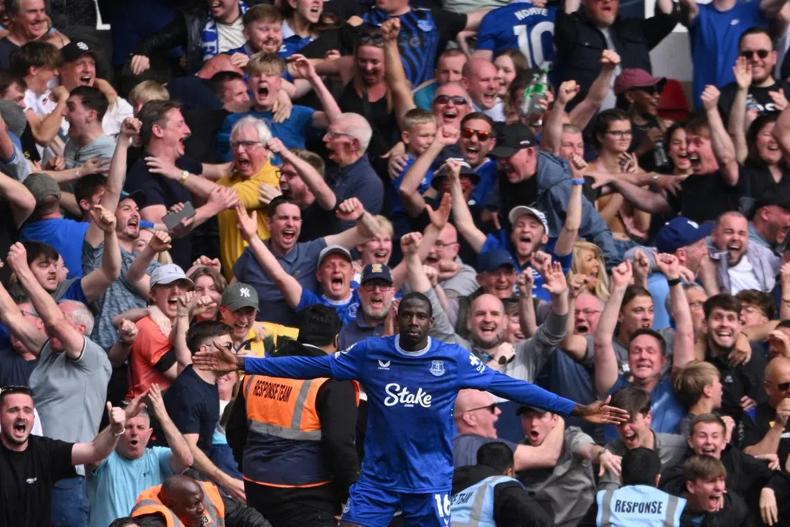 Midfielder Abdoulaye Doucoure celebrates after scoring in the 94th minute to win the match for Everton.