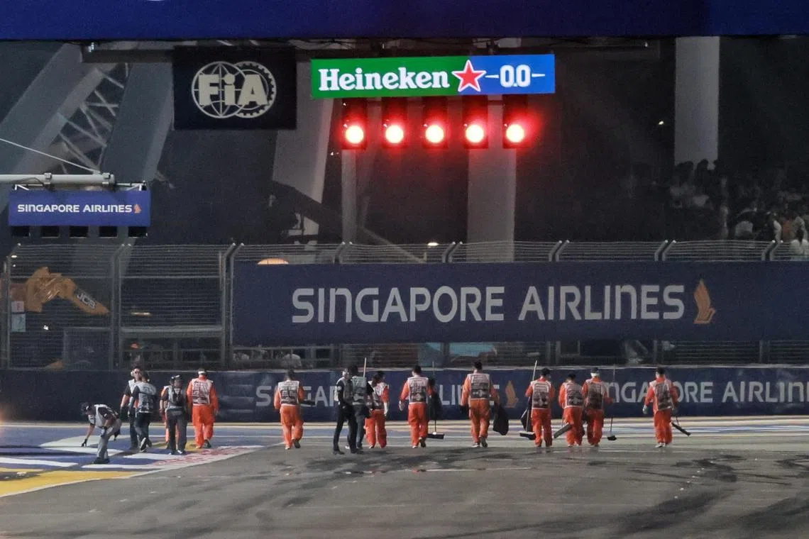 [NOTE: F1 photos are for editorial use only and NOT for sale] 

Staffs cleaning up the crash site after, 18 Lance Stroll of Aston Martin Aramco Cognizant F1 Team crashed near turn 19 during the qualifying session of the Formula One Singapore Airlines Singapore Grand Prix at Marina Bay street circuit on September 16, 2023.

ST Photo: Gin Tay