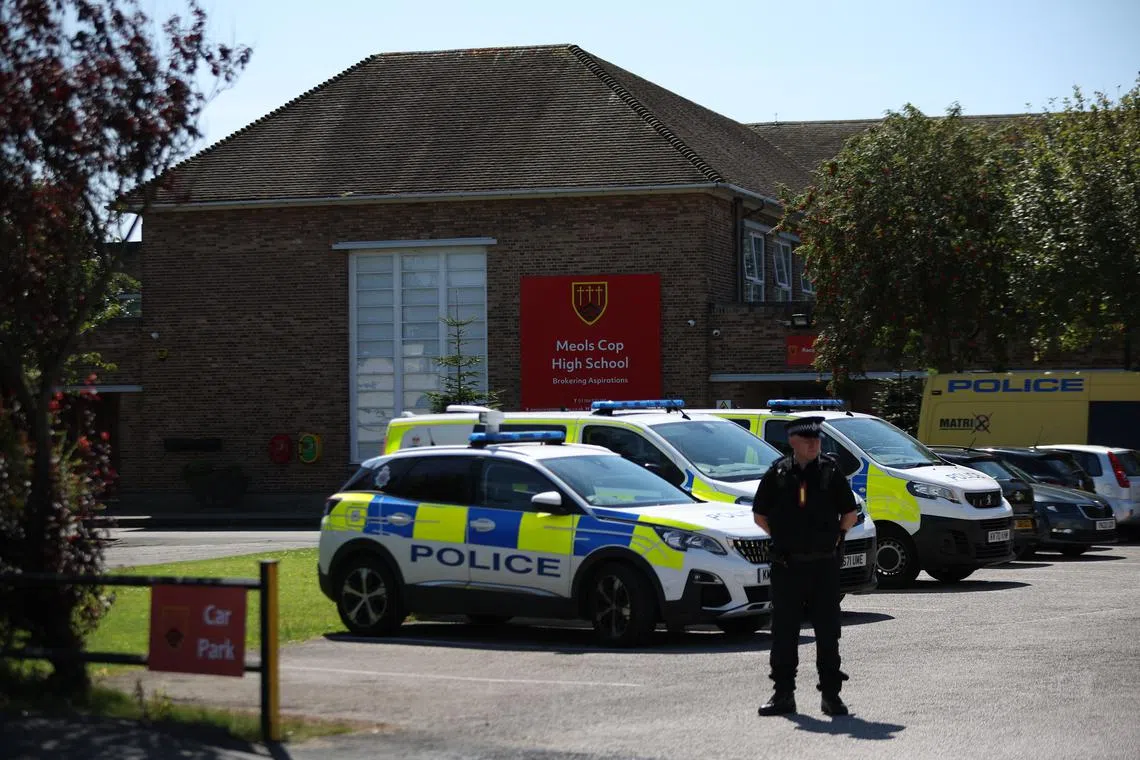 Police at the scene of suspected multiple stabbings at Meols Cop High School in Southport, Britain, on July 29.