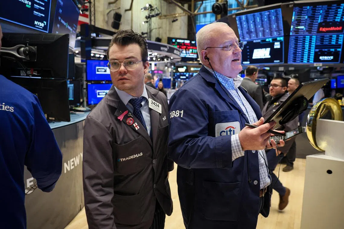 Traders work on the floor at the New York Stock Exchange, in New York City.