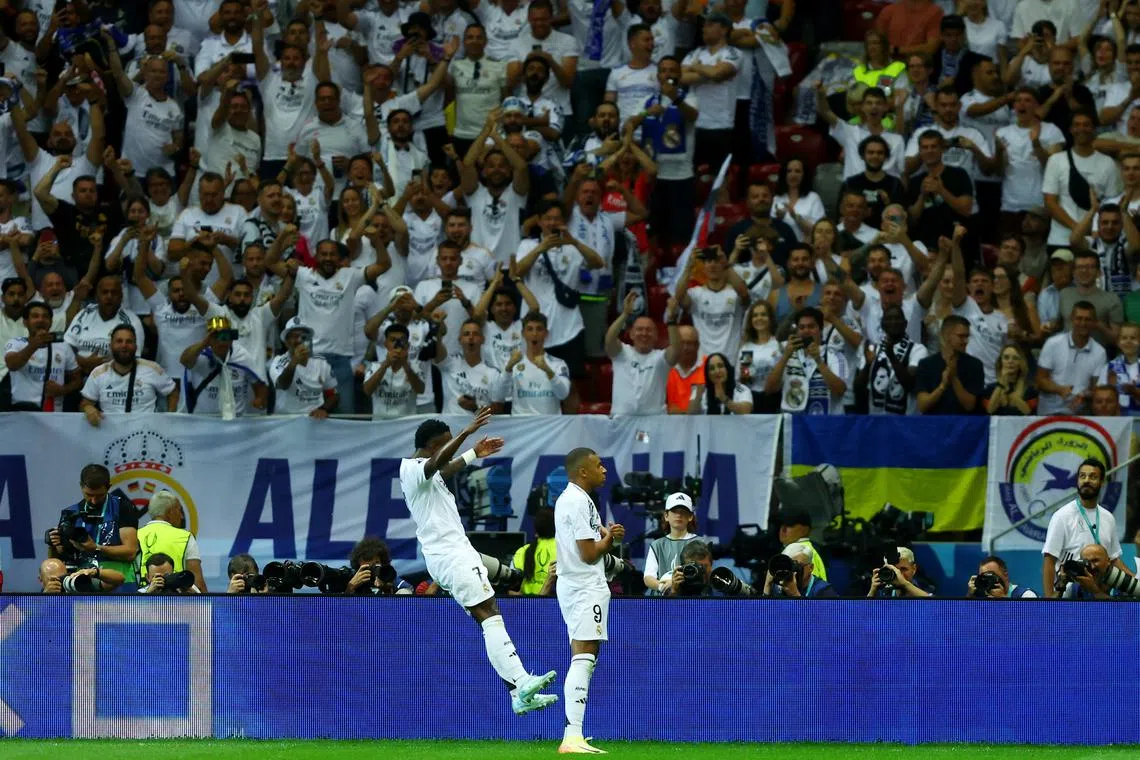 Soccer Football - Super Cup - Real Madrid v Atalanta - National Stadium, Warsaw, Poland - August 14, 2024 Real Madrid's Kylian Mbappe celebrates scoring their second goal with Vinicius Junior REUTERS/Kacper Pempel