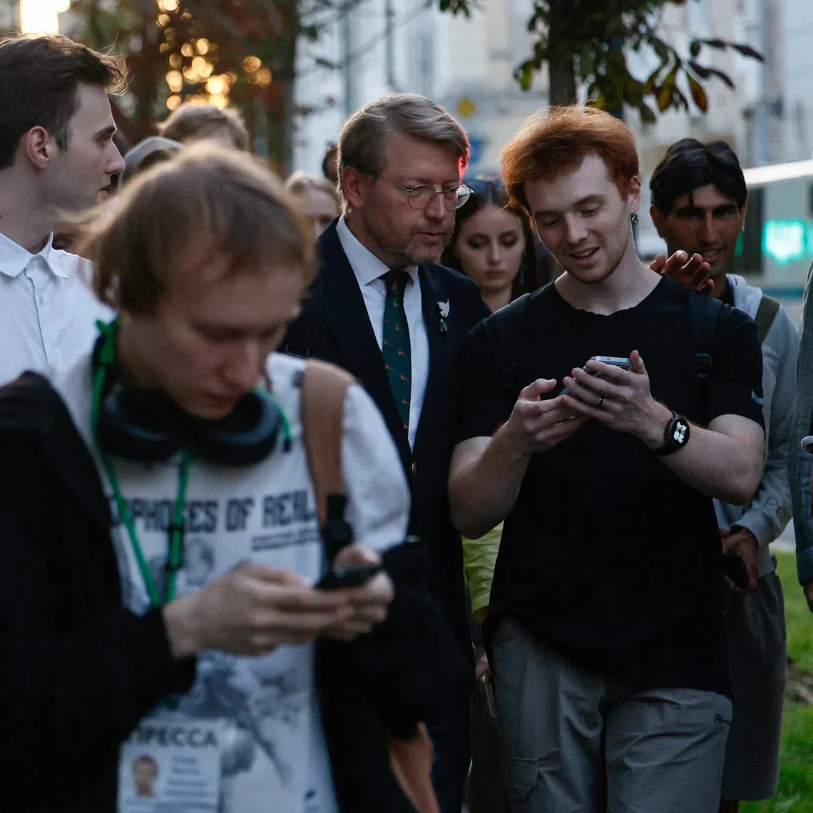 Chairman of Russia's Yabloko political party Nikolai Rybakov greets supporters after a hearing of the Supreme Court, which barred the party from contesting September's parliamentary elections over allegations of undeclared funding and breaches of campaigning rules, in Moscow, Russia, August 10, 2026. REUTERS/Yulia Morozova