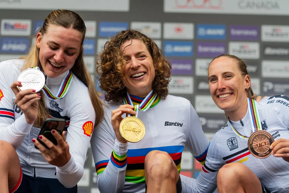 (From left) Silver medalist Zoe Backstedt of Britain, gold medalist Marlen Reusser of Switzerland, and bronze medalist Franziska Koch of Germany pose on the podium for the Women’s Elite Time Trial at the UCI Road Cycling World Championships in Montreal, Canada.