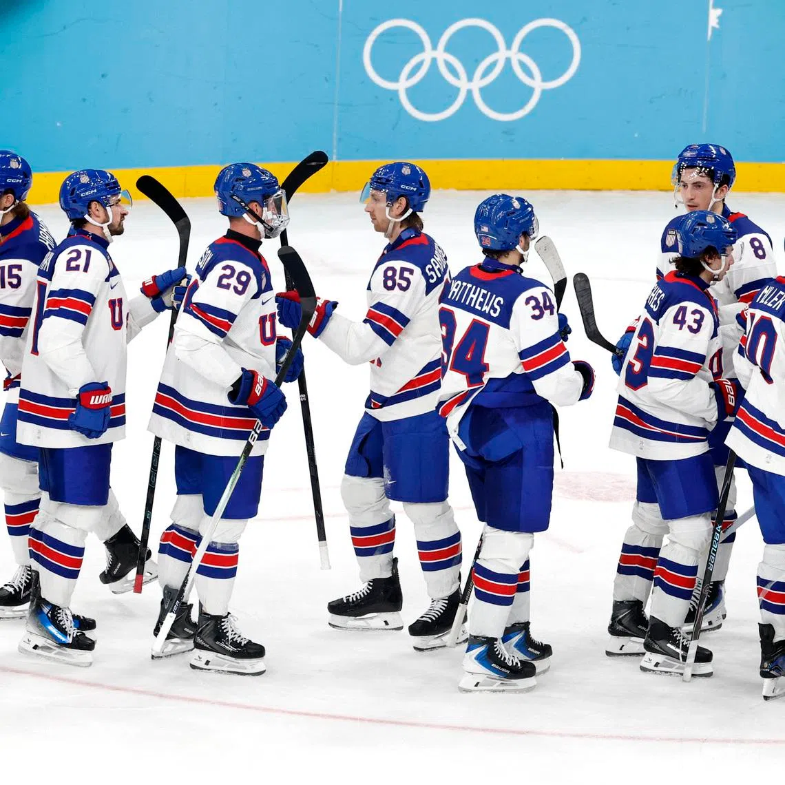 Milano Cortina 2026 Olympics - Ice Hockey - Men's Play-offs Semifinals - United States vs Slovakia - Milano Santagiulia Ice Hockey Arena, Milan, Italy - February 20, 2026. Jake Sanderson of United States with teammates celebrate after the match REUTERS/David W Cerny