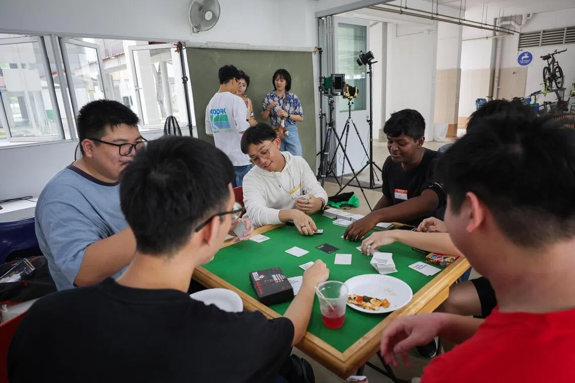 Youth converged around mahjong tables and card games at a community space within a Yishun HDB void deck on Sept 19, hoping to connect with someone new.