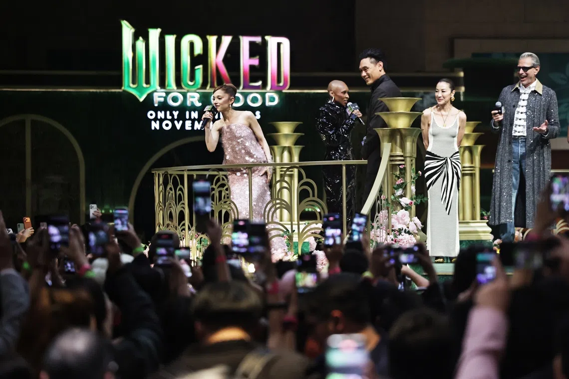 From left- Ariana Grande, Cynthia Erivo, director Jon M Chu, Michelle Yeoh and Jeff Goldblum greeting fans at RWS Weave before the premiere for Wicked: For Good in Universal Studios Singapore on Nov 13, 2025.