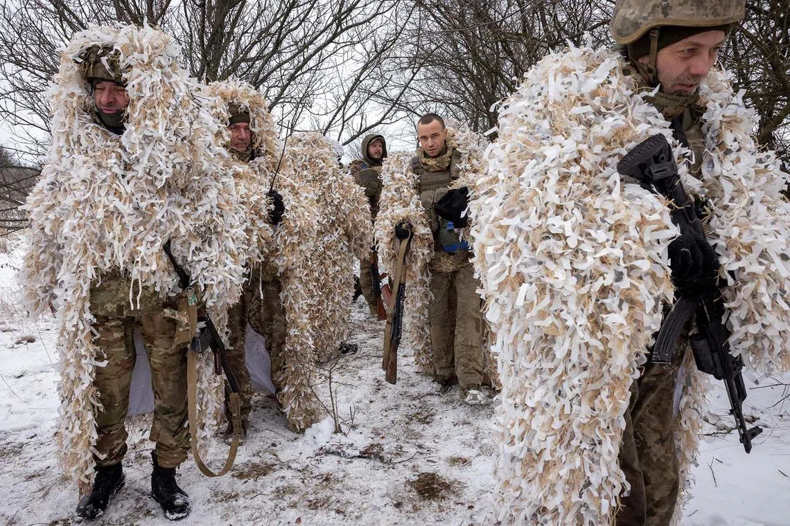 Ukrainian servicemen wearing ghillie suits during training near the front line in the Donetsk region, amid Russia’s attack on Ukraine, Dec 25, 2023. 