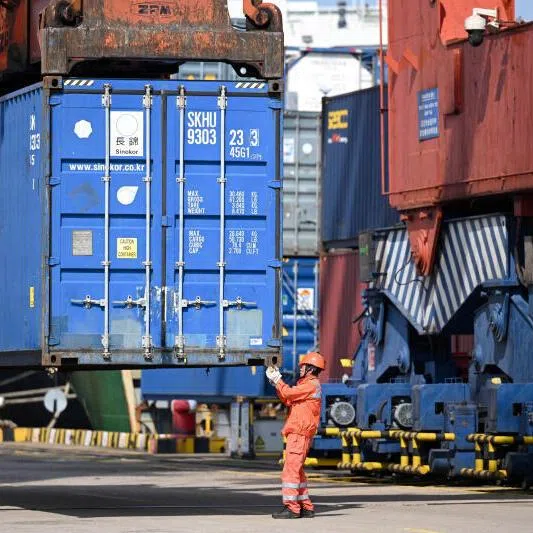 A crane lifts a container at the port of Zhangjiagang, Jiangsu province, China. Inflation risks tied to the global energy shock will dominate Asia’s economic calendar in the coming week.