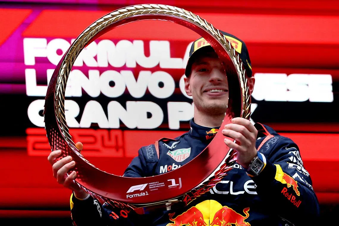 Formula One F1 - Chinese Grand Prix - Shanghai International Circuit, Shanghai, China - April 21, 2024 Red Bull's Max Verstappen celebrates with the trophy on the podium after winning the Chinese Grand Prix REUTERS/Edgar Su