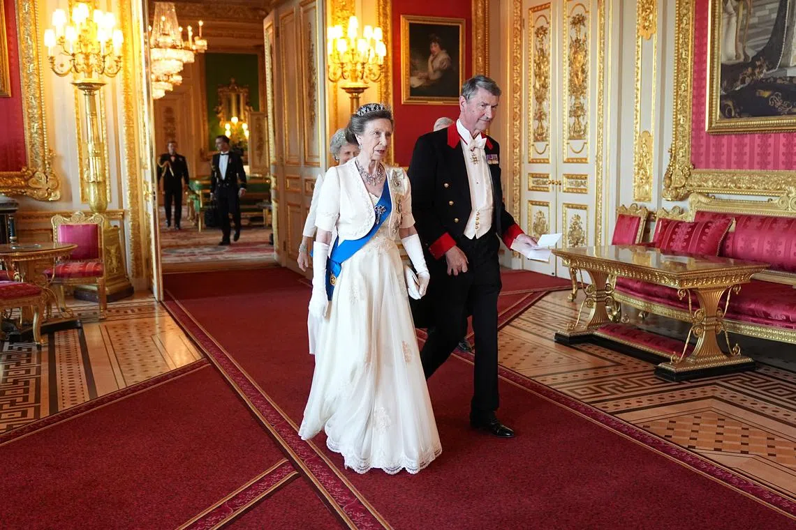 Britain's Princess Anne, Princess Royal and and her husband Vice Admiral Sir Tim Laurence arrive for the State Banquet for President of France Emmanuel Macron and his wife Brigitte Macron, on day one of the French President's state visit to the UK, at Windsor Castle, Berkshire, Britain, July 8, 2025.  Aaron Chown/Pool via REUTERS/File Photo