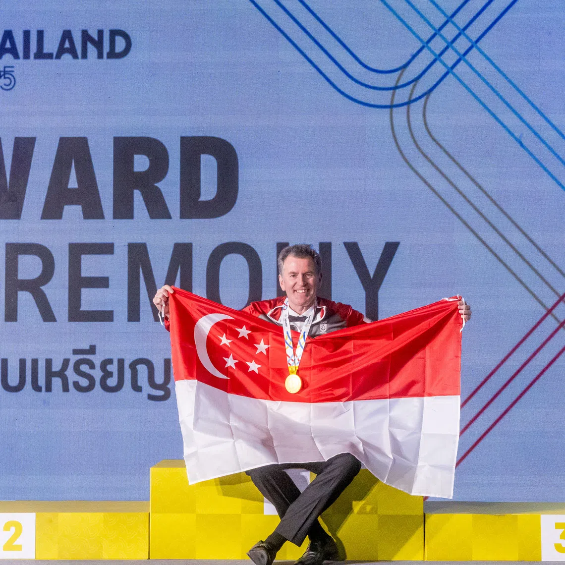 Singapore's Peter Gilchrist celebrates his gold medal.