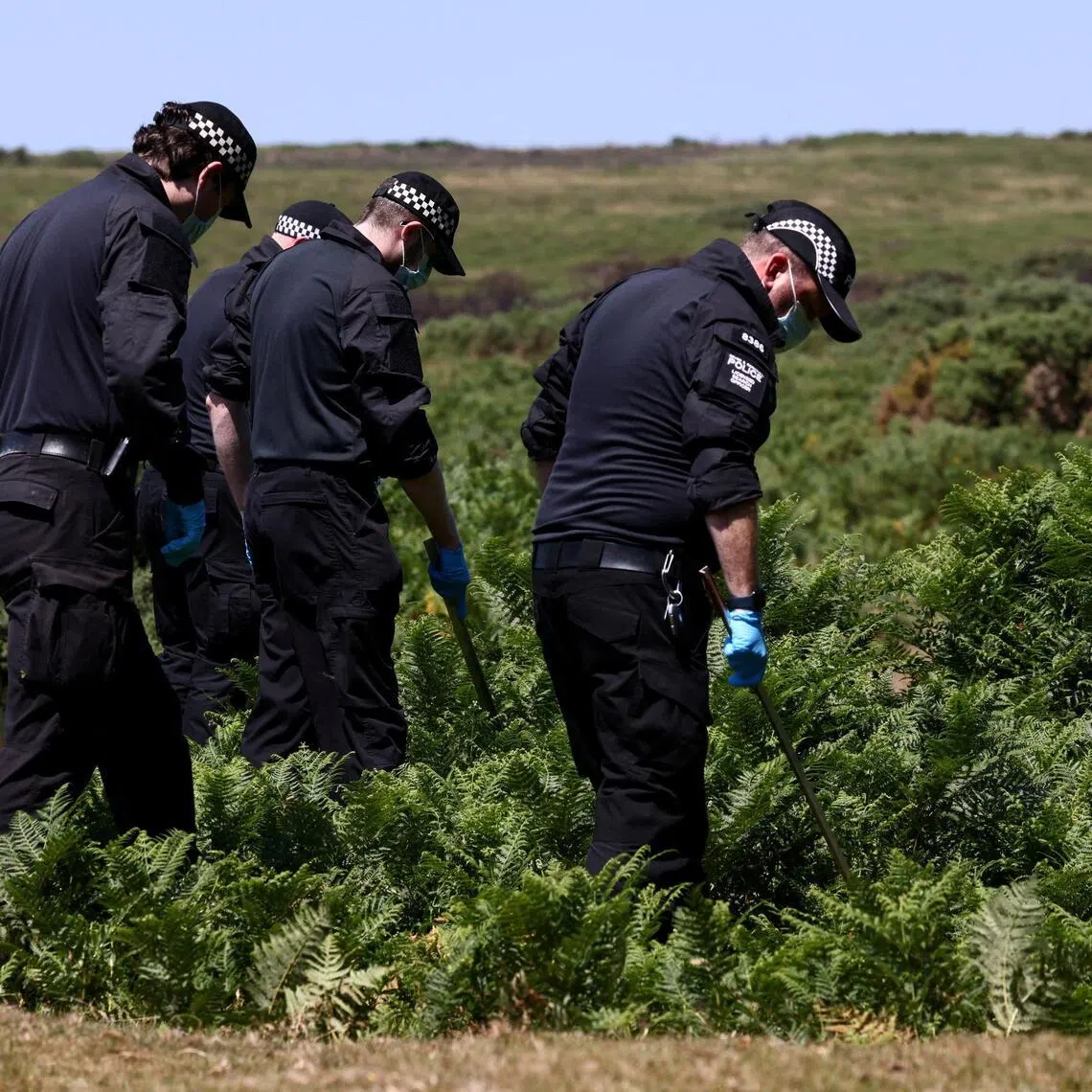 Police officers investigate the area near the home of former British government minister Ann Widdecombe after she was found dead, in Haytor, Britain on July 11.