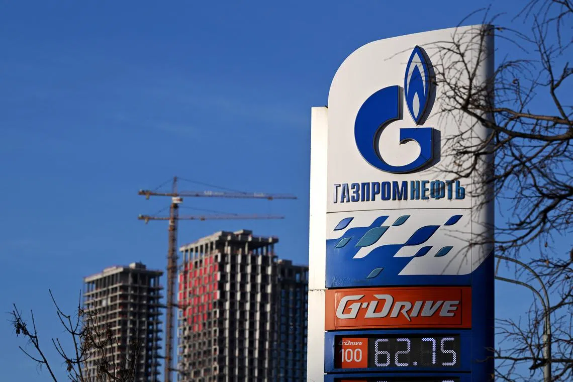 A view of a petrol station of the Russian oil producer Gazprom Neft and high-rise residential buildings under construction in Moscow on January 12, 2023. (Photo by Natalia KOLESNIKOVA / AFP)